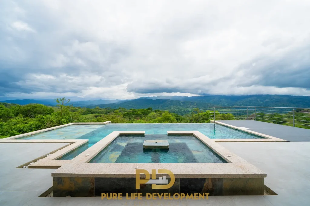 Infinity pool overlooking lush green mountains